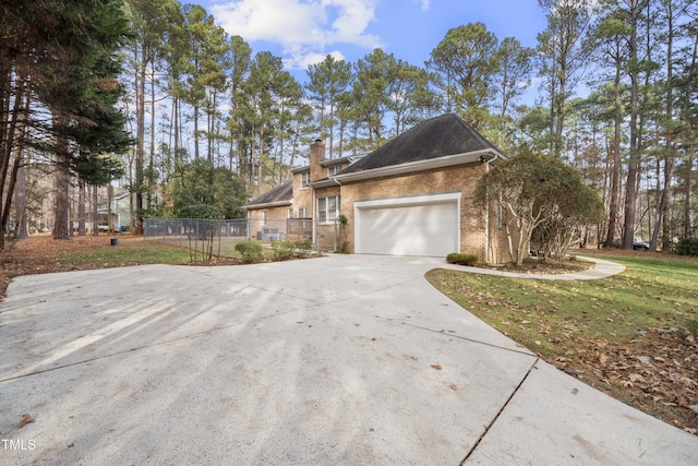 view of side of home with a yard and a garage