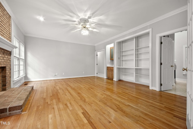 unfurnished living room with ornamental molding, light hardwood / wood-style flooring, and a brick fireplace