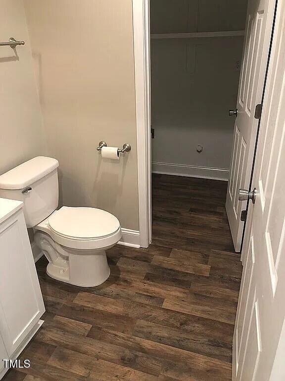 bathroom featuring hardwood / wood-style flooring, vanity, and toilet