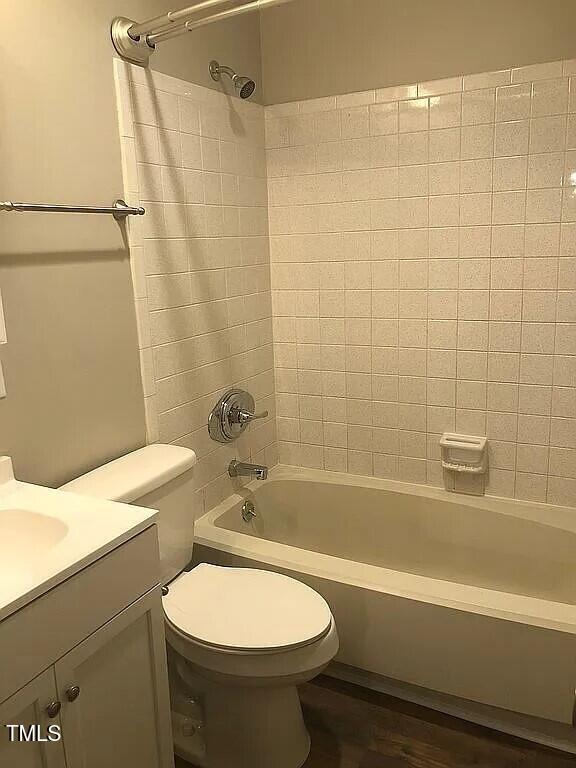 full bathroom with vanity, toilet, and tiled shower / bath