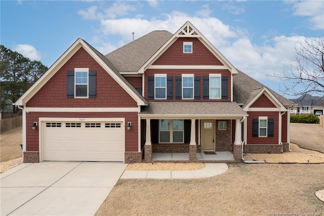 craftsman-style home with a porch, a garage, a shingled roof, brick siding, and concrete driveway