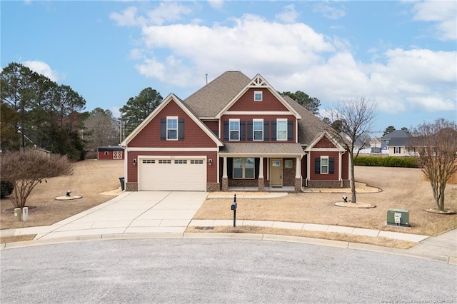 craftsman-style house featuring a garage, a shingled roof, and concrete driveway