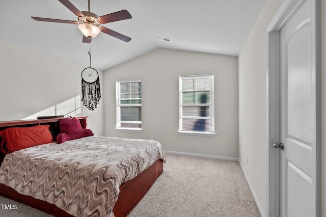 bedroom with vaulted ceiling, ceiling fan, and carpet flooring