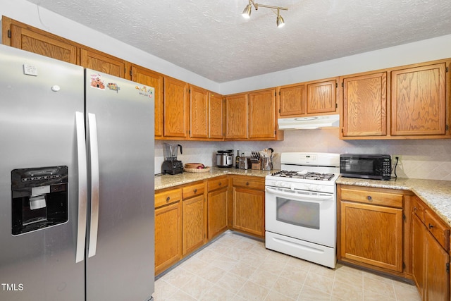 kitchen featuring a textured ceiling, white gas range, and stainless steel refrigerator with ice dispenser