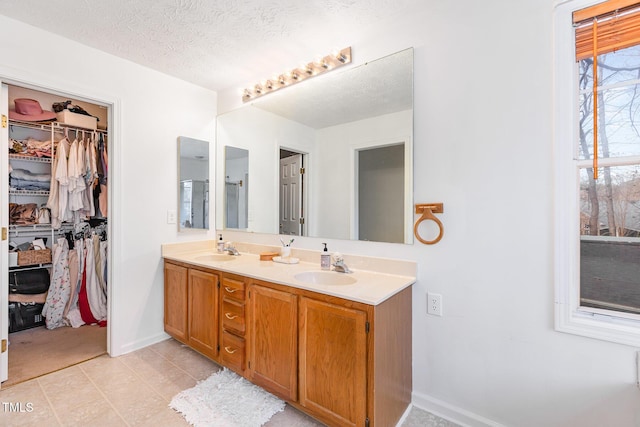 bathroom with vanity and a textured ceiling