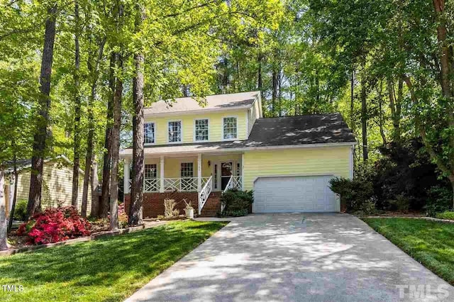 view of front of home featuring a porch, a garage, and a front lawn