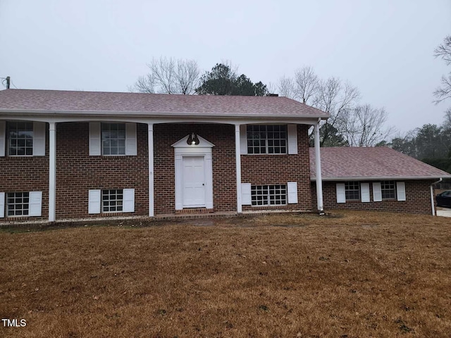 raised ranch featuring a front lawn