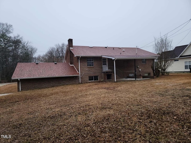 rear view of property featuring a lawn and a patio