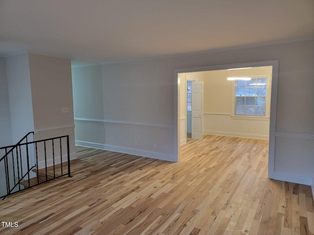 unfurnished room featuring crown molding and light hardwood / wood-style flooring