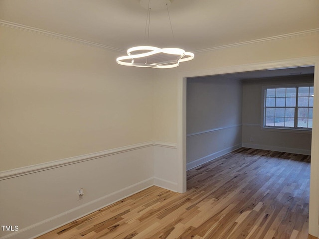 unfurnished dining area featuring hardwood / wood-style floors and ornamental molding