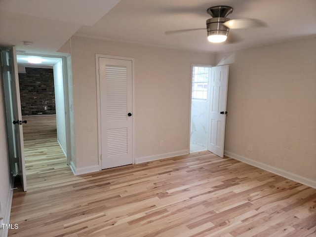 unfurnished bedroom with ceiling fan, a closet, light hardwood / wood-style floors, and ornamental molding