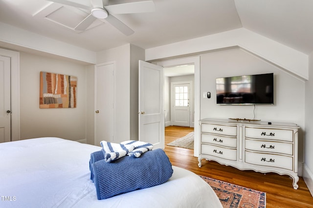 bedroom featuring ceiling fan, hardwood / wood-style floors, and lofted ceiling