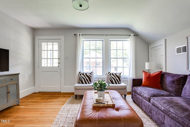 living room featuring vaulted ceiling and light hardwood / wood-style flooring