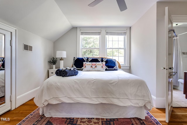 bedroom featuring ceiling fan, lofted ceiling, and hardwood / wood-style flooring