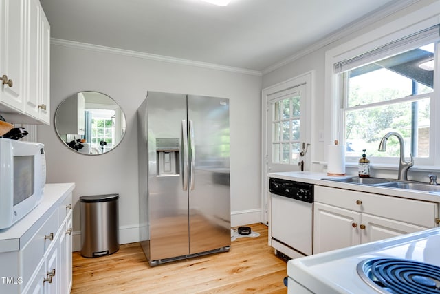 kitchen with white cabinetry, white appliances, and sink