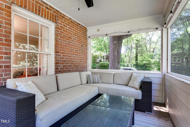 sunroom / solarium featuring ceiling fan