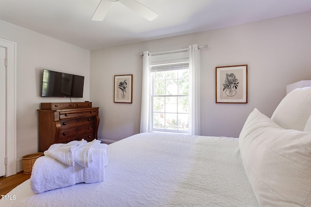 bedroom with ceiling fan and wood-type flooring