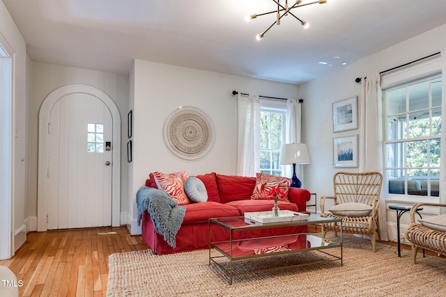 living room with hardwood / wood-style floors and an inviting chandelier