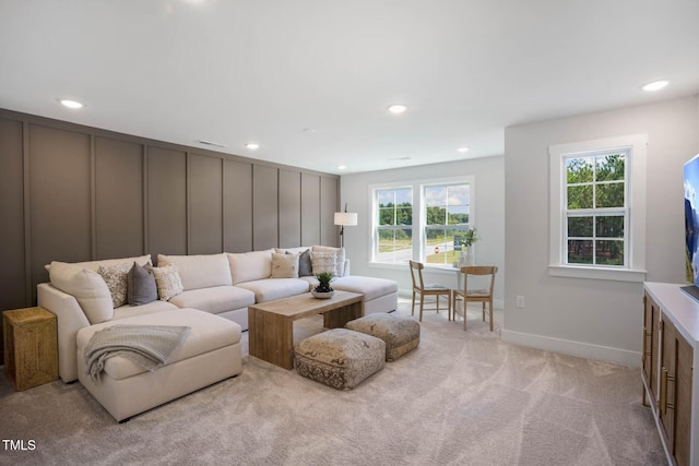 living area with recessed lighting, light colored carpet, visible vents, and baseboards