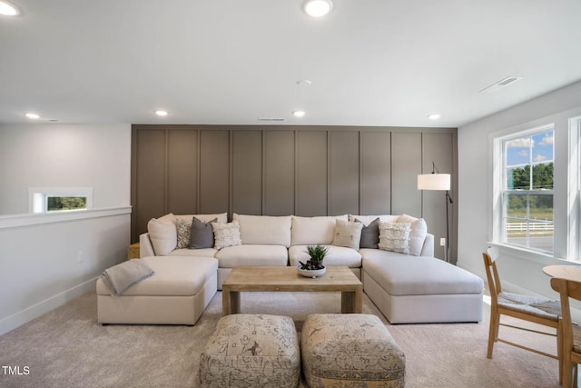 living room featuring baseboards, recessed lighting, visible vents, and light colored carpet