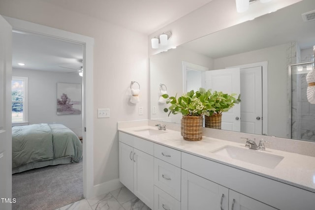 bathroom featuring vanity, ceiling fan, and a shower with door