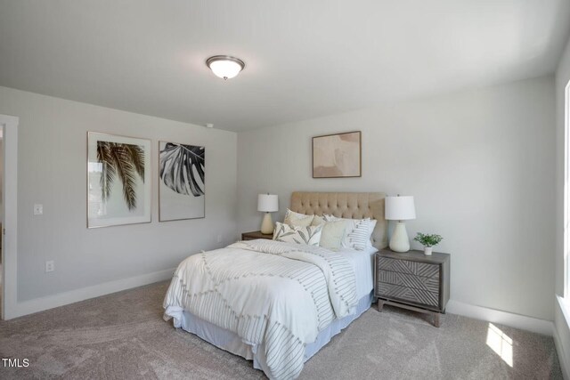 carpeted bedroom featuring visible vents and baseboards