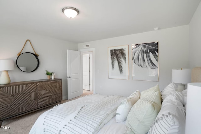 carpeted bedroom featuring visible vents