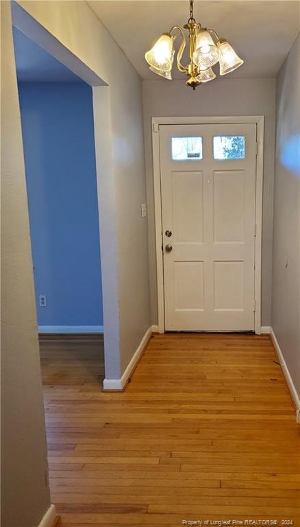 entryway featuring a chandelier and light hardwood / wood-style flooring