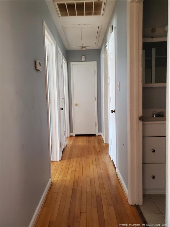 corridor featuring light hardwood / wood-style floors