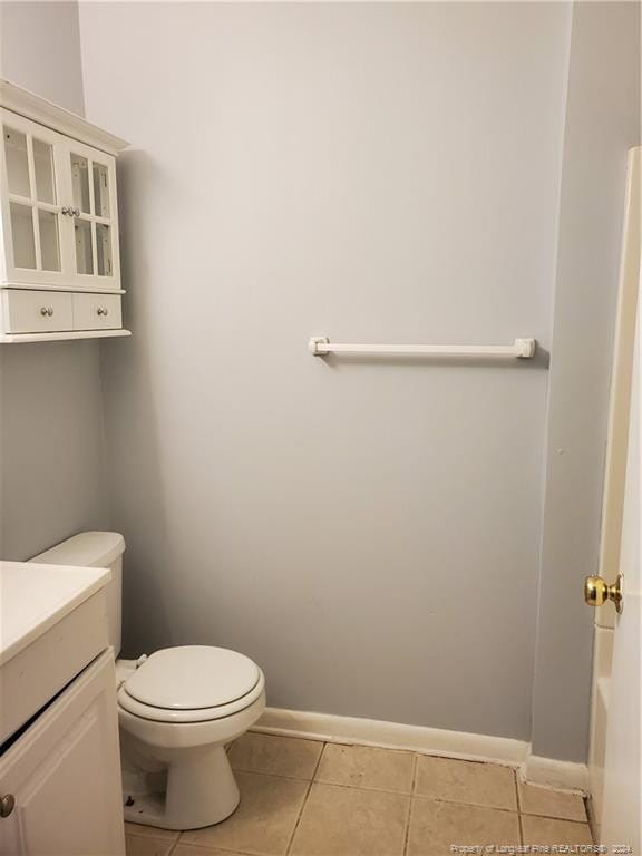 bathroom featuring tile patterned floors, vanity, and toilet