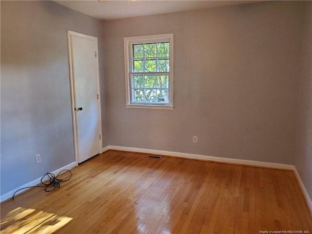 unfurnished room with light hardwood / wood-style floors