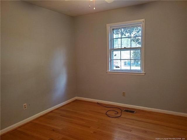 empty room with hardwood / wood-style floors