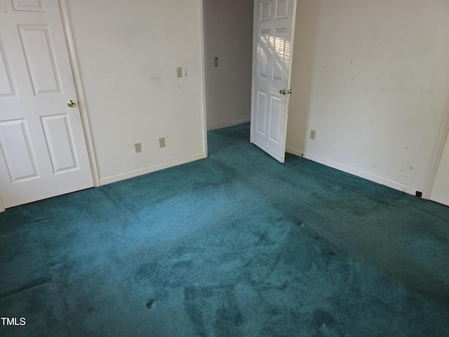 spare room featuring dark carpet