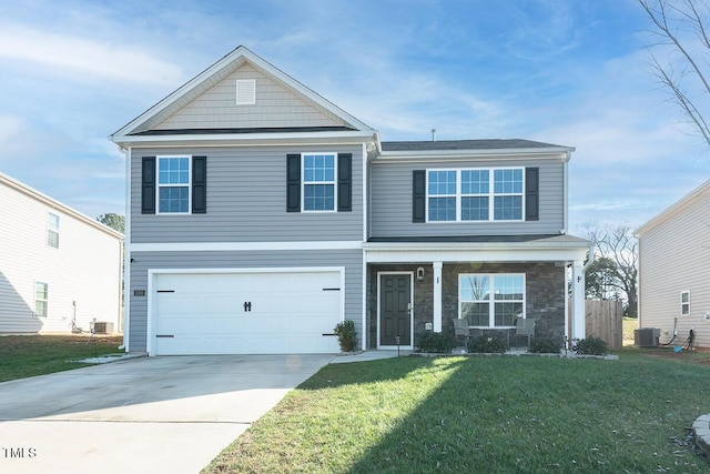 view of property with central AC unit, a front yard, and a garage