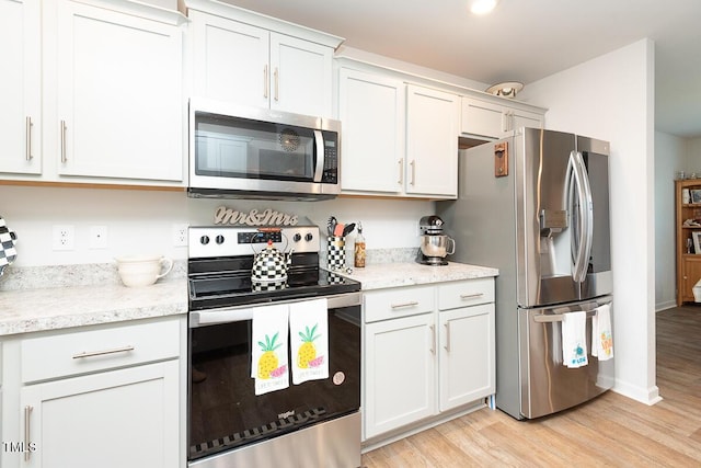 kitchen featuring white cabinets, appliances with stainless steel finishes, and light wood-type flooring