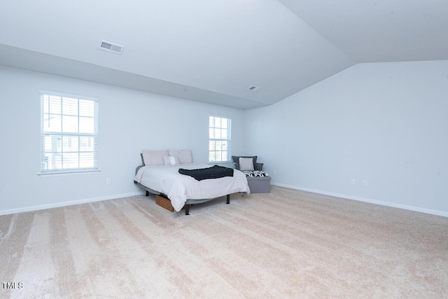 carpeted bedroom featuring lofted ceiling