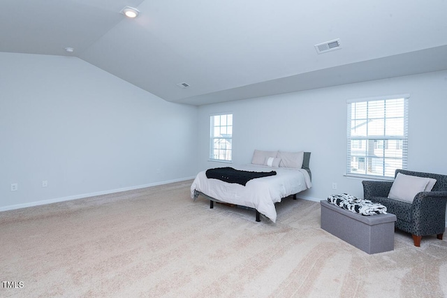 bedroom featuring multiple windows, light carpet, and vaulted ceiling