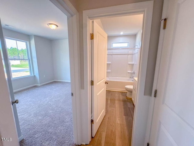 corridor with light colored carpet