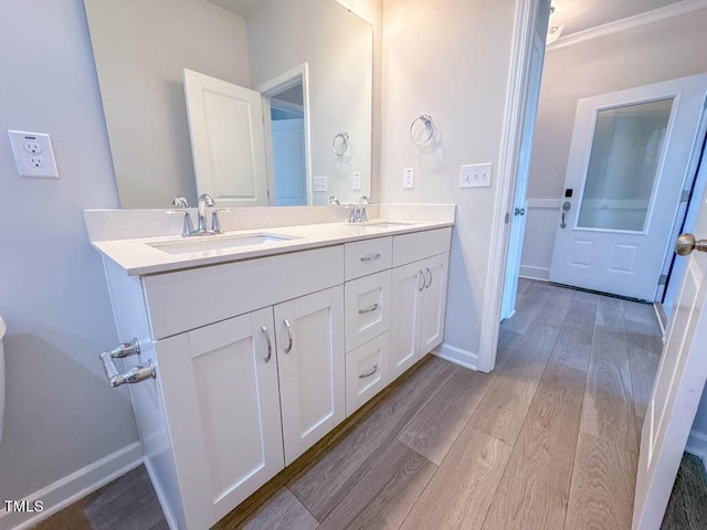 bathroom with hardwood / wood-style floors and vanity