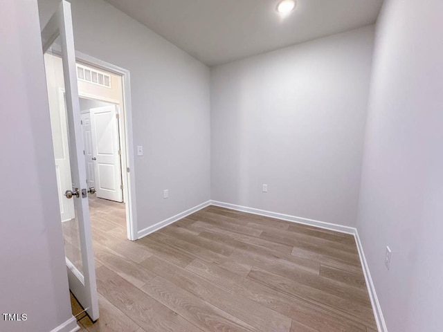 empty room with light hardwood / wood-style floors