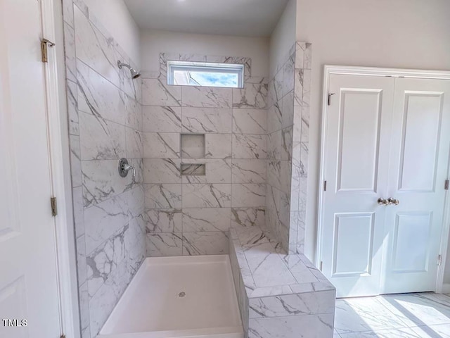 bathroom with tiled shower