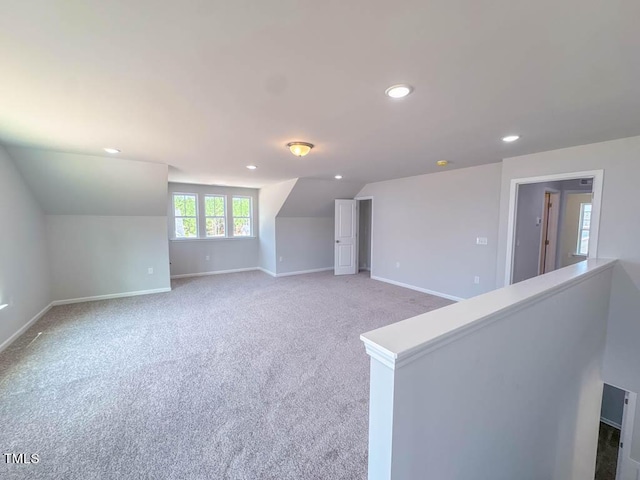 unfurnished living room with lofted ceiling and carpet floors