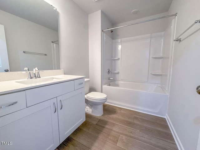 full bathroom with hardwood / wood-style floors, vanity, toilet, and tub / shower combination