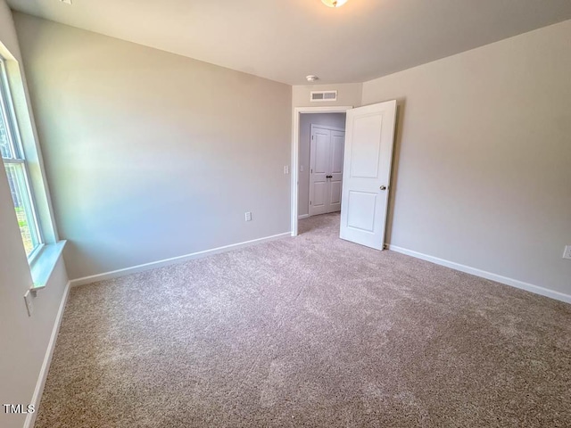 unfurnished room featuring carpet flooring