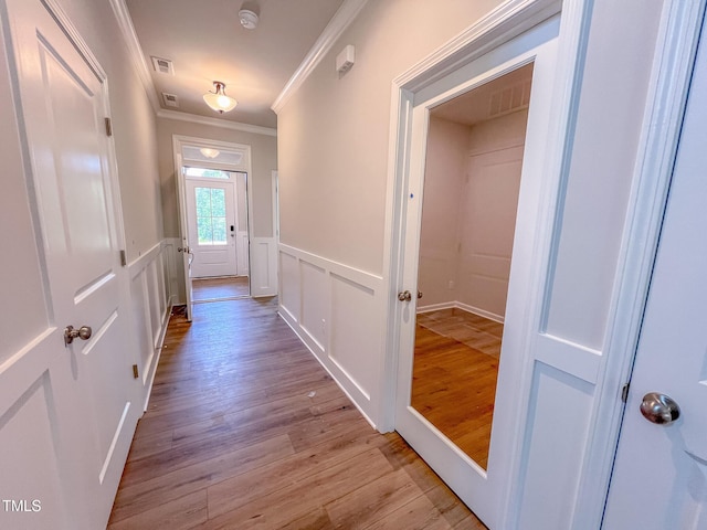 403 Duncan Creek Rd # 131, Lillington, NC 27546 - hallway featuring ornamental molding, light wood-type flooring, a wainscoted wall, and a decorative wall