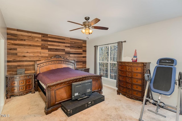 carpeted bedroom with ceiling fan and wooden walls