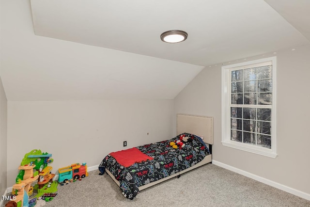 carpeted bedroom featuring vaulted ceiling