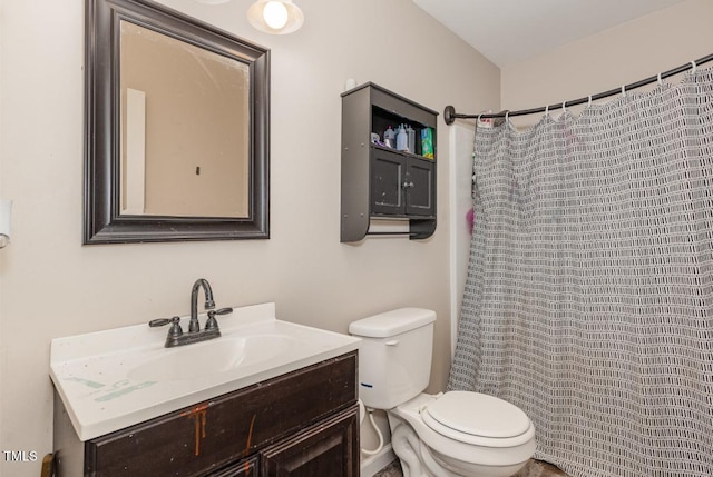 bathroom featuring vanity, toilet, and walk in shower