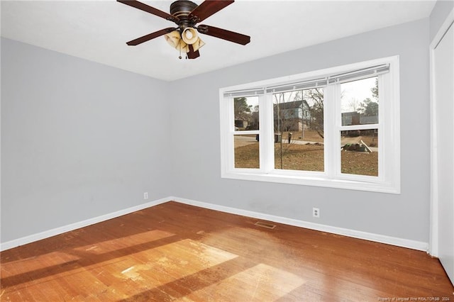 unfurnished room with ceiling fan and hardwood / wood-style floors