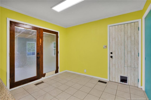 interior space featuring ornamental molding, light tile patterned floors, and french doors